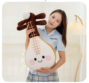 Adorable cartoon Pipa lute musical instrument plush toy held by a model in a cozy setting