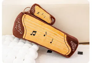 Close-up detail of simulated zither plush toy featuring delicate musical note embroidery