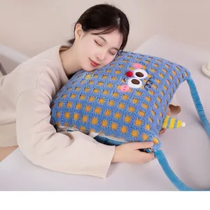 Soft plush cartoon 2-in-1 pillow blanket shown in use by a model for a cozy office nap
