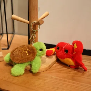Adorable plush sea animal keychains featuring a green turtle and a red crab mascot