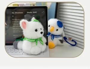Detailed view of cute seagull and arctic fox plush keychains in a cozy desk setting