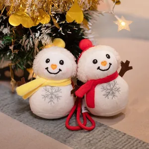 Cute plush Christmas snowman hanging ornaments with yellow and red scarves in festive setting