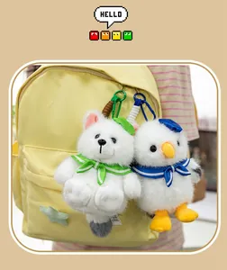 Detail view of cute plush seagull and arctic fox keychains hanging on a backpack