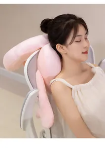 Close-up of soft pink bunny ear neck pillow used on office chair for comfortable nap