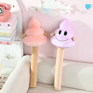 Detail view of cute poop emoji plush back-massage hammers in pink and purple colors