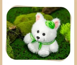 Close-up detail of a cute white plush fox doll with a green bow on a green mossy background