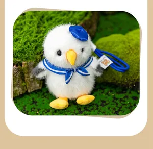 Close-up of a cute fluffy seagull plush pendant wearing a blue sailor hat and collar
