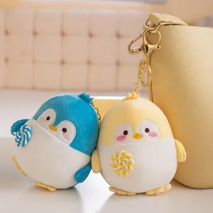 Cute plush penguin keychains with lollipops, blue and yellow cartoon bag charm pendants