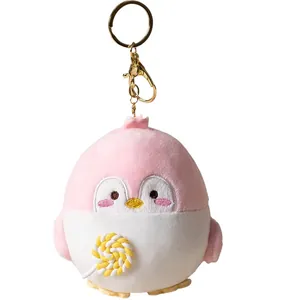 Pink plush penguin keychain with yellow lollipop design for backpack charm decoration