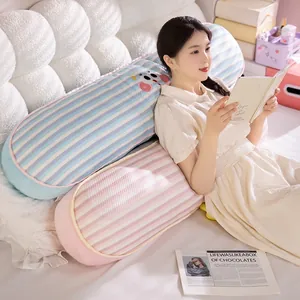 Long striped ice silk bolster pillow used for back support while reading in bed.