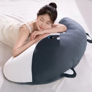 Comfortable large whale plush sleeping pillow cushion with Asian model on white bed