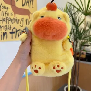 Detail of yellow plush capybara phone bag with cute embroidered paw prints