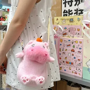 A detailed view of the soft pink capybara plush crossbody bag with orange head decor