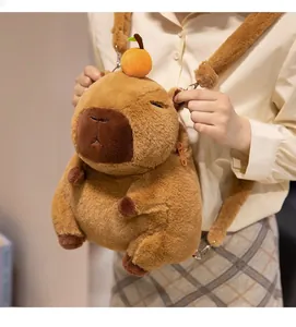 Detailed view of a soft brown capybara plush backpack with a cute orange decoration.