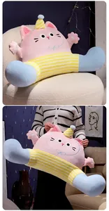 Cute pink cat plush backrest pillow shown on a cozy chair and held by a model