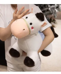 Detailed view of a cute white plush pony mascot with soft brown fur accents.