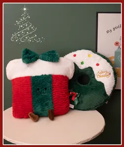 Close-up of festive plush gift box and wreath pillows with soft texture details.