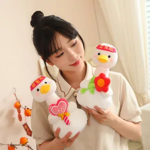 Two cute white duck plush toys with heart and flower accessories being held by a young woman