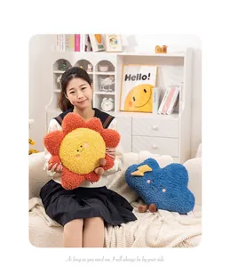Sun and cloud shaped plush pillows shown in a cozy home lifestyle setting.