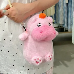 Close-up detail of a cute pink plush hippo crossbody phone bag with soft fur texture