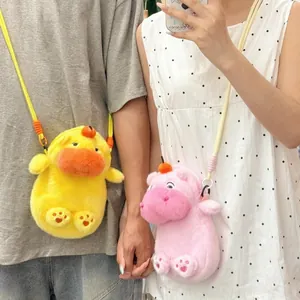 Detail shot of cute yellow and pink plush capybara crossbody bags worn by a couple.