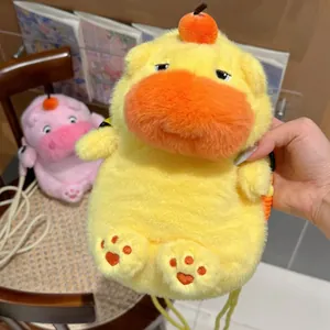 Detailed view of a cute yellow plush Capybara bag with small orange hair accessory