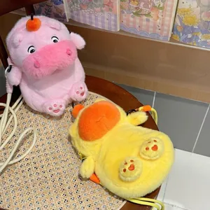 Pink and yellow capybara plush phone bags with cute expressions on a woven chair