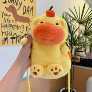 Cute yellow capybara plush phone bag with funny expression and orange fruit detail.