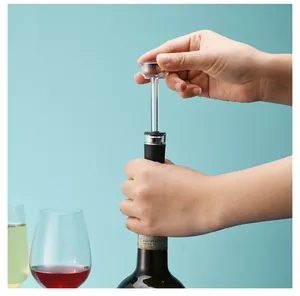 Action shot showing the use of a vacuum wine stopper pump on a bottle of red wine
