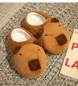 Close-up detail of cute brown capybara plush slippers on a cozy woven textured mat