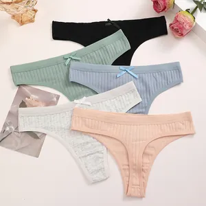 Close-up detail of multi-colored cotton ribbed thongs featuring delicate bow accents