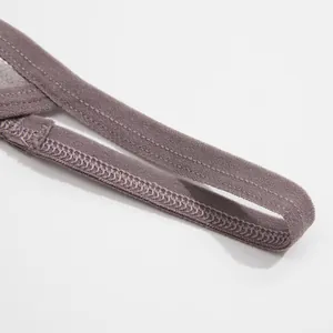 Macro detail of high-quality stitching on a grey lace thong strap for women