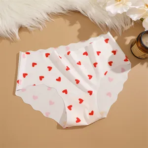Seamless ice silk women briefs with cute red heart print, mid-waist comfortable underwear.