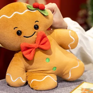 Simpatico cuscino di peluche a forma di pan di zenzero natalizio con un papillon rosso