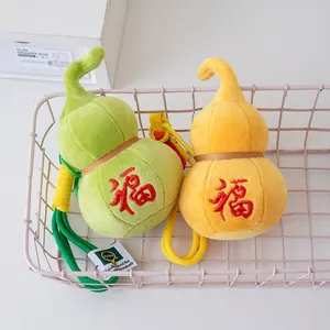 Pair of plush gourd lucky charm keychains with red Fu embroidery in green and yellow