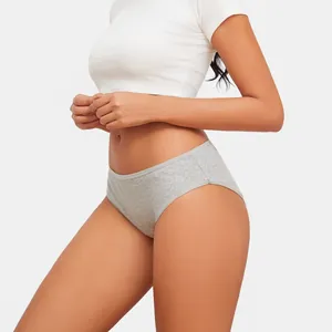 Detail view of grey ribbed cotton low-waist briefs for women on a fit model.