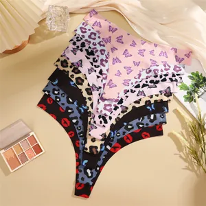 Detailed view of seamless low rise women thong set featuring butterfly leopard and lip prints.