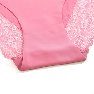 Detailed macro view of pink seamless women's panties featuring delicate lace stitching.