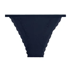 Detail view of navy blue ribbed women's panties with delicate lace trim edges