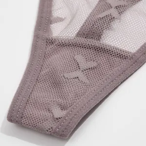 Close-up detail of the sheer mesh lace fabric and stitching on a grey thong underwear