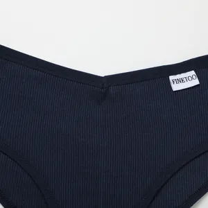 Close-up detail of dark navy blue ribbed cotton V-waist Brazilian panties with label
