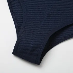 Close-up detail showing texture of navy blue ribbed cotton fabric on high-cut thong panties