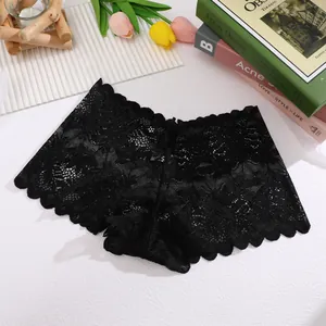 Close-up of black floral lace underwear with delicate scalloped edges and soft texture.