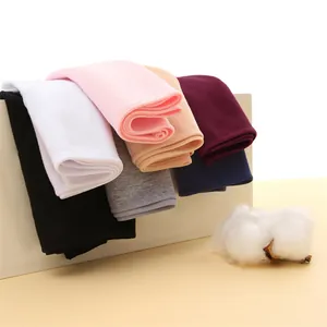 Macro detail of multi-color breathable cotton briefs displayed with a raw cotton boll