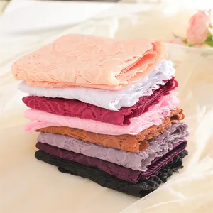 Detailed view of stacked colorful lace high-waisted panties in various shades
