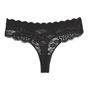 Close-up view of a sexy black lace thong showing intricate translucent floral patterns and edges.