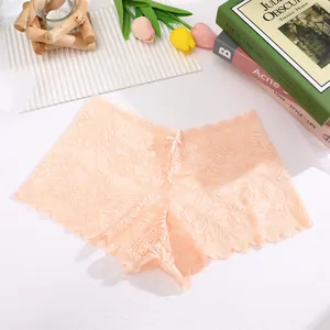 Close-up of delicate peach floral lace panties showing intricate mesh texture