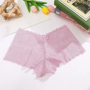 Close-up of elegant light purple sheer lace panties with bow detail on white textured background