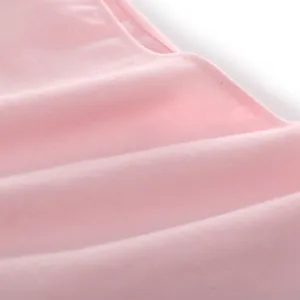 Detailed close-up of soft pink cotton fabric showing fine knit texture and stitching detail