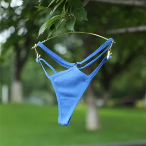 Detailopname van de blauwe geribbelde naadloze string met dubbele tailleband en gouden accenten